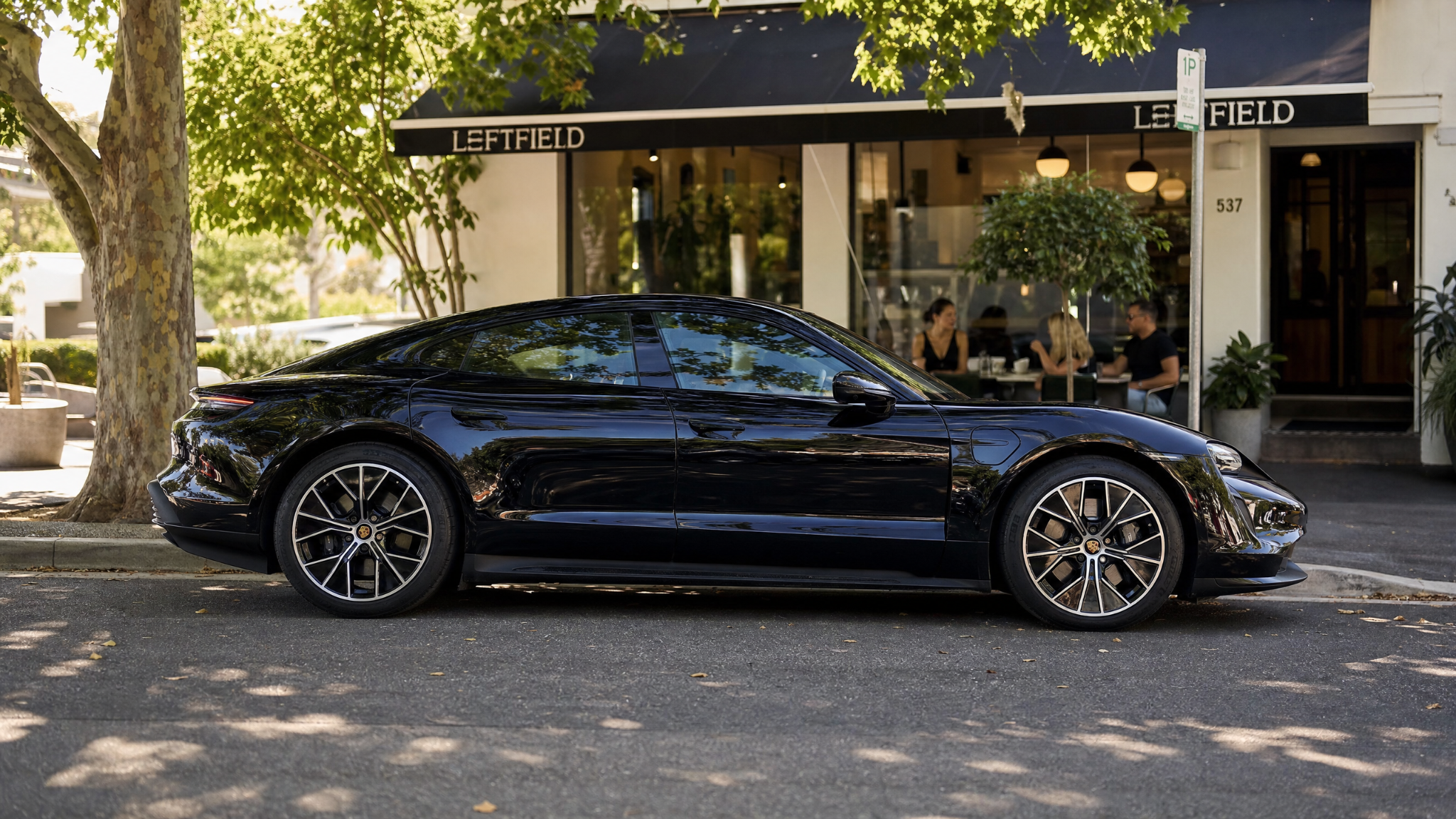 Black Porsche Taycan parked on an Australian street